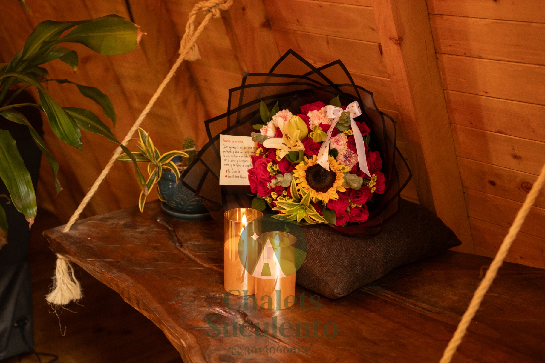 Ramo de flores sobre columpio de madera con vela encendida